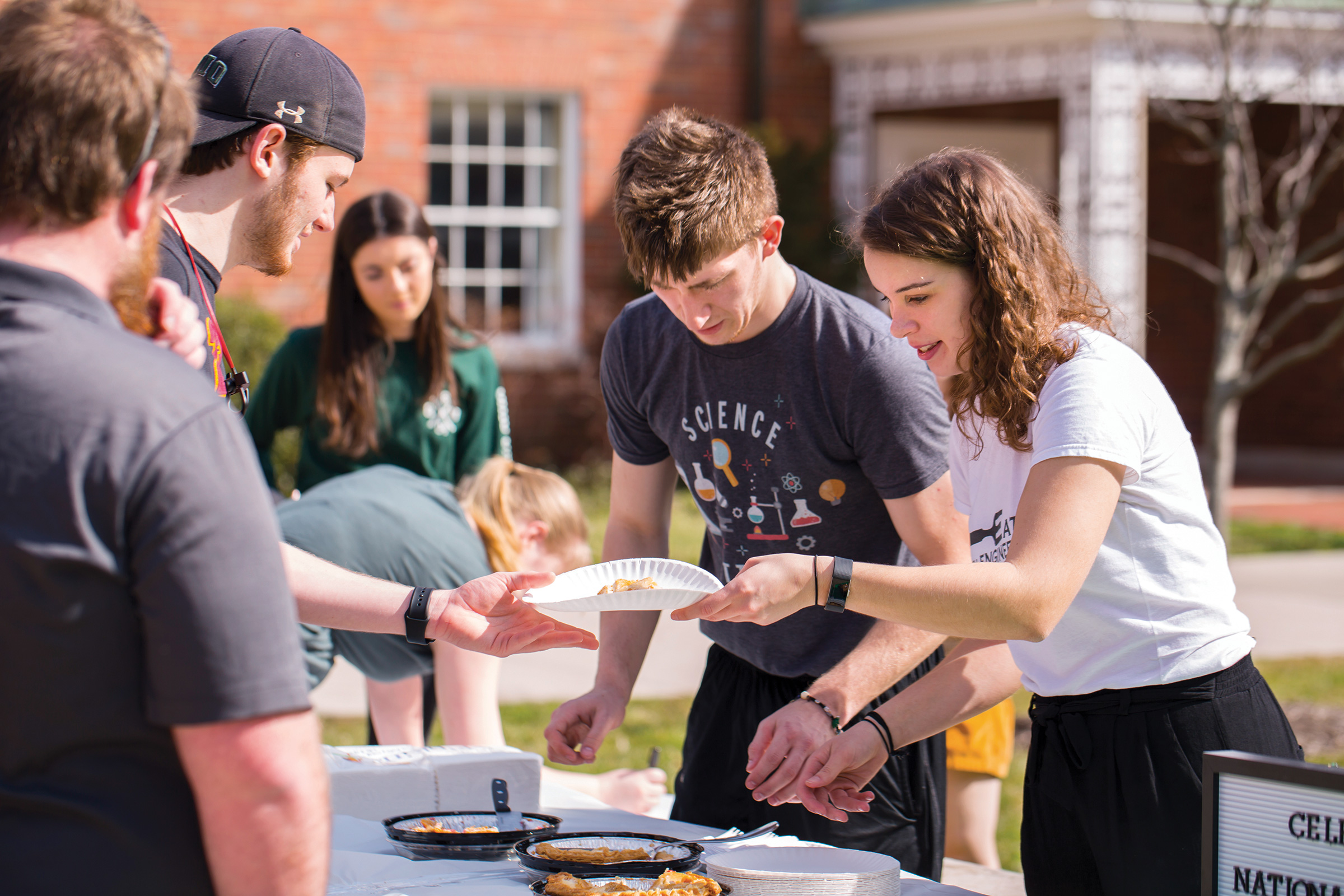 Students serving food at picnic